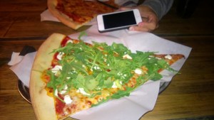 This is one slice of pizza. The iPhone is in the photo so you can get a sense of how big that slice really is!